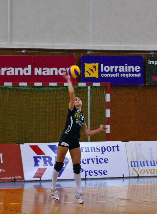 a lady getting ready to hit a volleyball