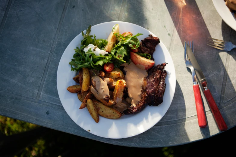 the white plate is full of food on the table