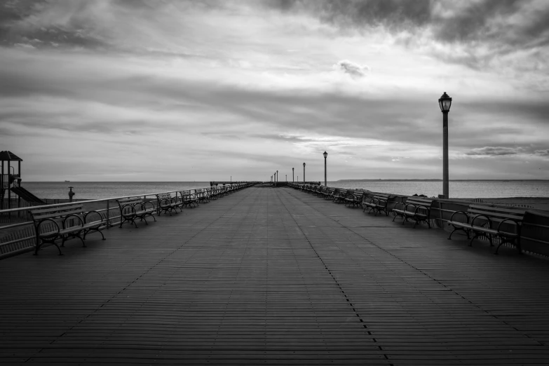 a long pier sitting on top of a sandy beach