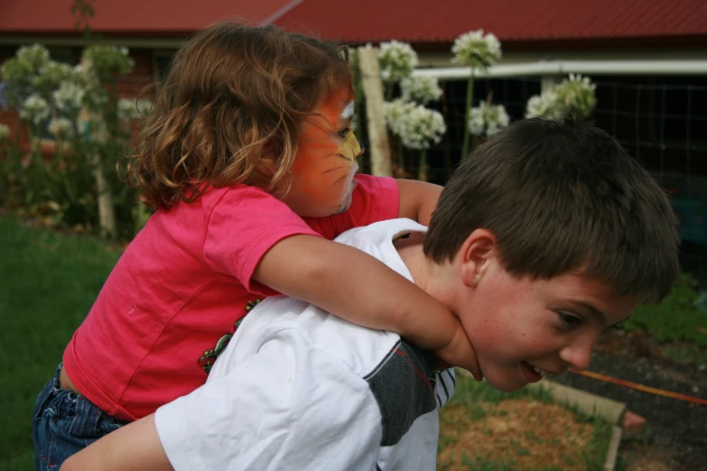 a boy and girl are hugging each other