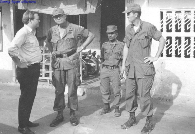 four men standing on the side of a building