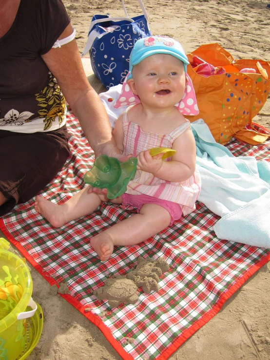 a small baby is sitting on a towel