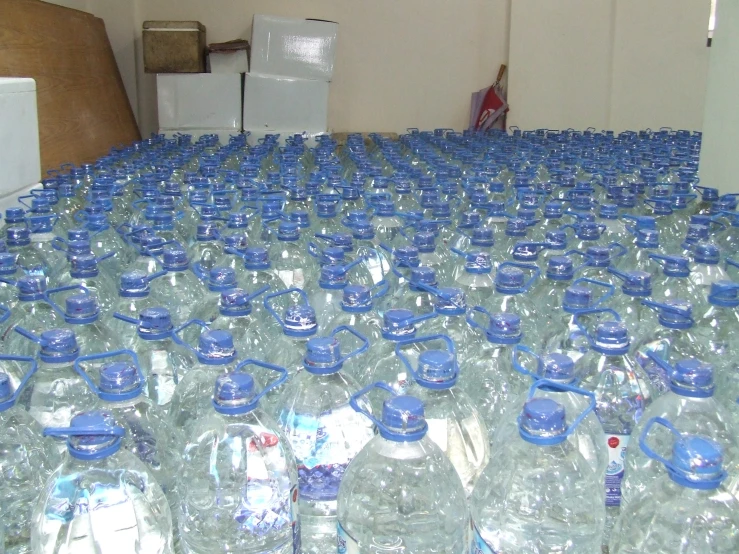 many plastic water bottles on top of a table