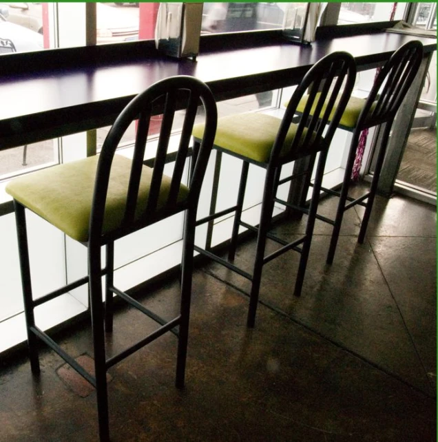 three chairs sitting on a counter in a restaurant