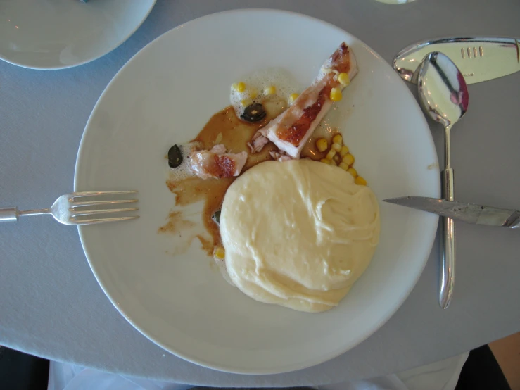 a white plate with a fork and some vegetables on it