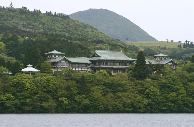 the building on the hill has many levels and canopies on them