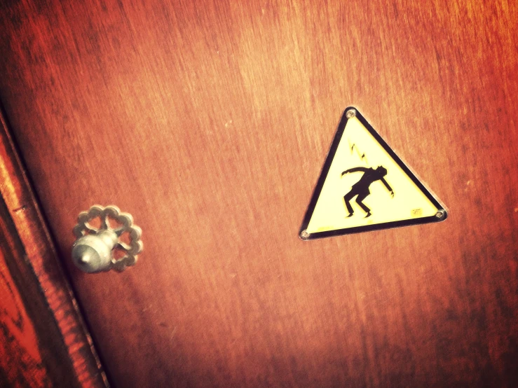 a wooden door with a sticker of a man on it