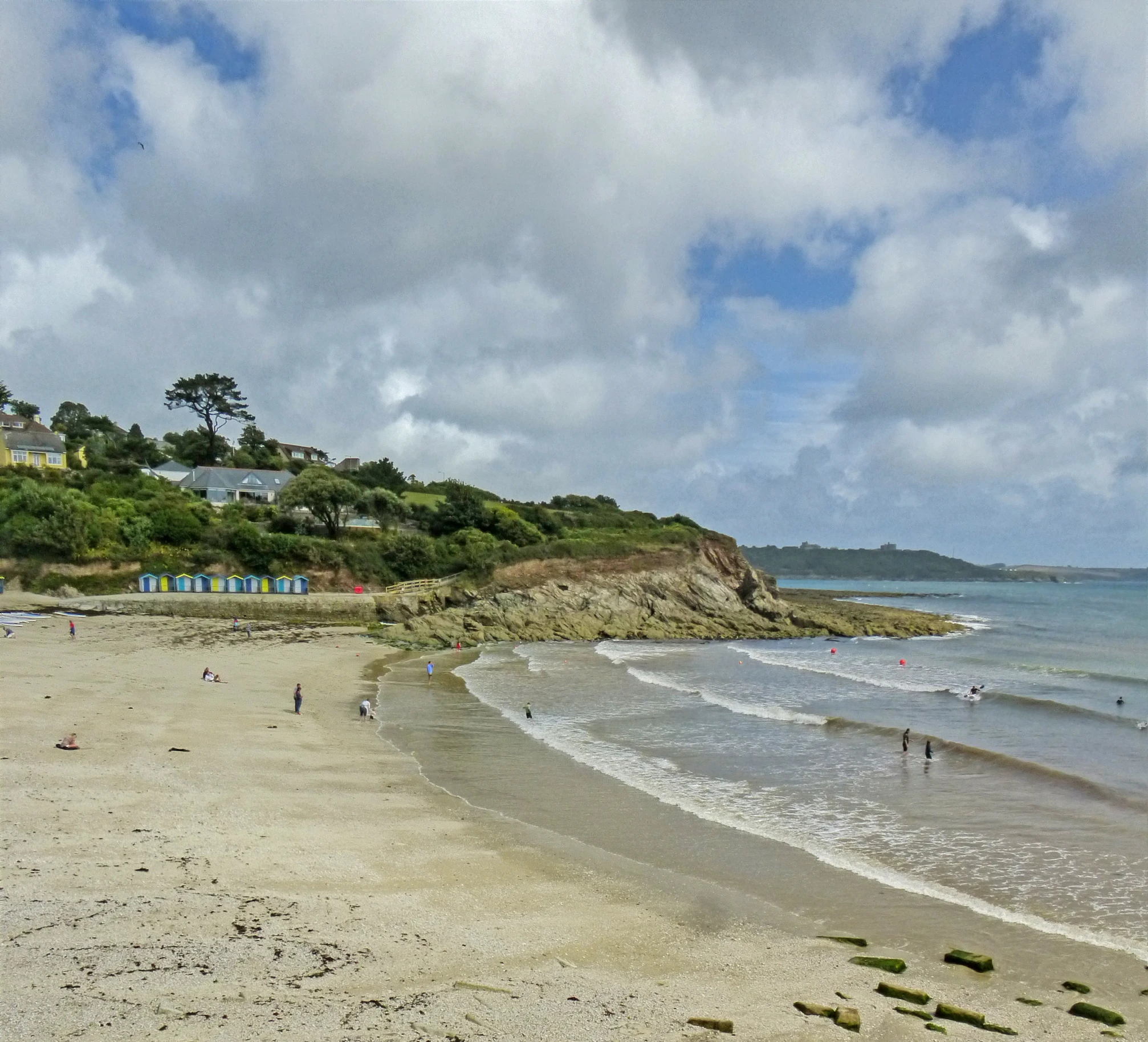 a body of water with a sandy beach next to it