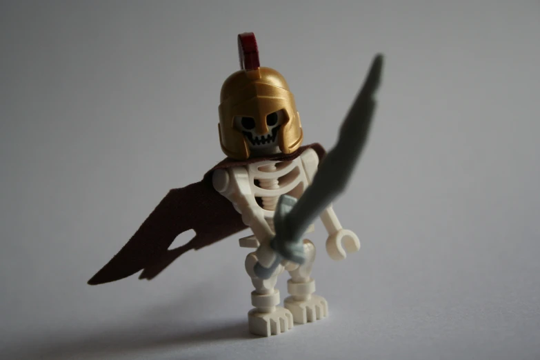 a lego figure with a sword and skeleton