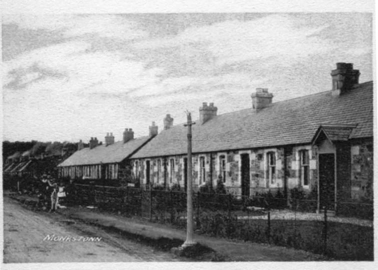 an old black and white po of people next to old buildings