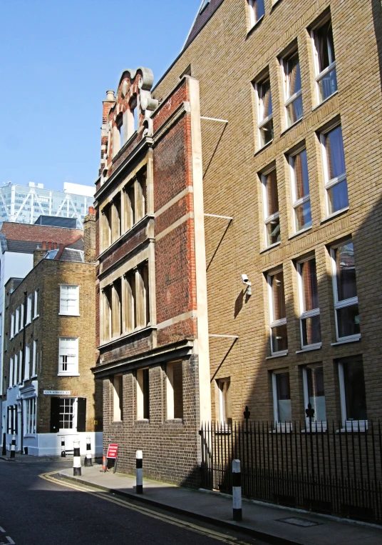 a very long brick building on the corner of a street