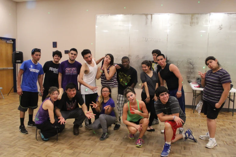 a group of young people posing in a building