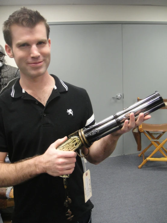 man holding a gun and looking at his reflection