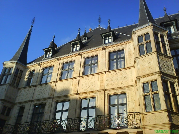 an old building has steeples and an iron balcony