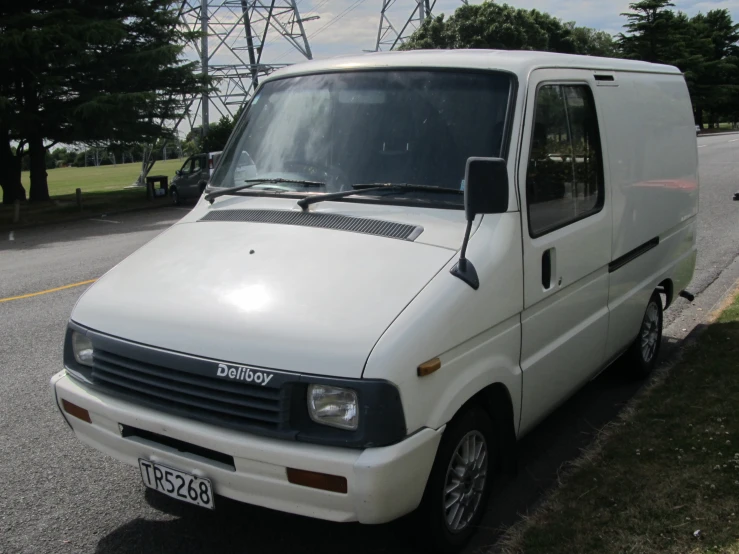 a small van with two windows on the street