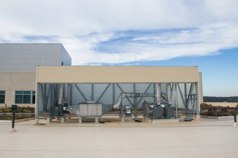 the back entrance of a building under a blue cloudy sky