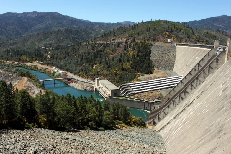 there is a large dam on the side of a mountain