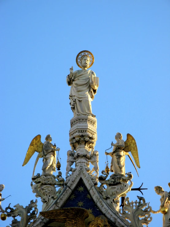 a fancy building has angels on top of it