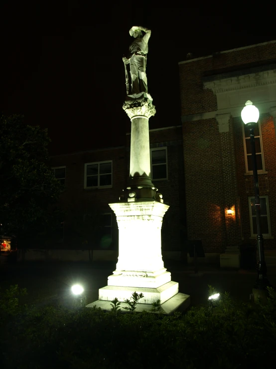 a light up monument in front of a building at night