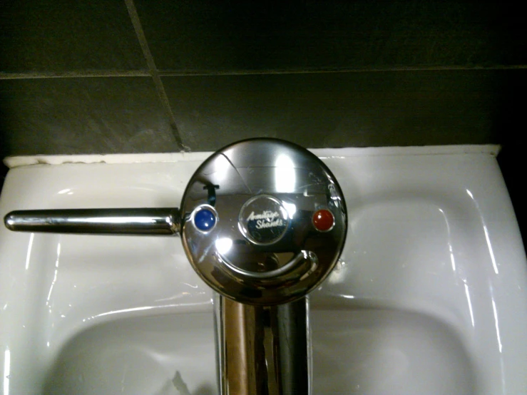 a small white public bathroom sink