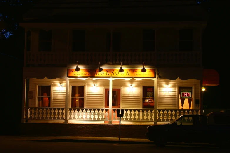 a white building with awnings and windows covered in lamps