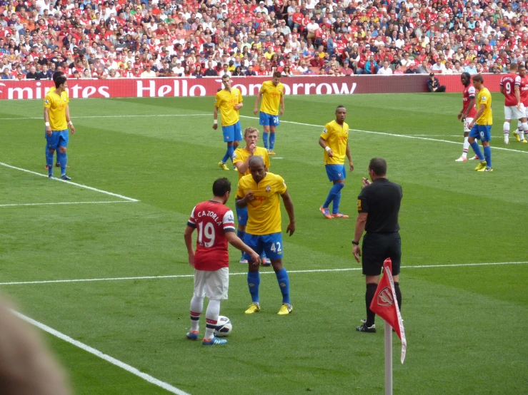 soccer players on field with crowd behind