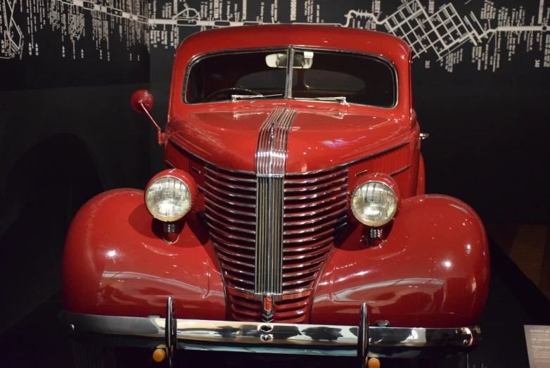 an old fashioned red truck is on display