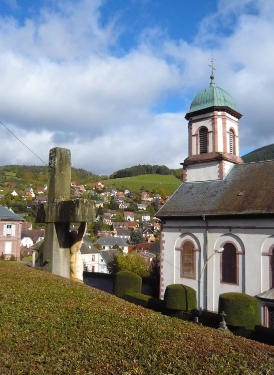 a small white church on the top of a hill