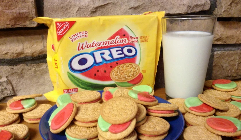 a plate of watermelon cookies next to a bag of oreo