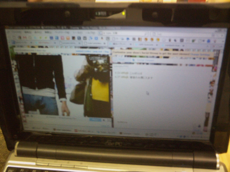 an open laptop computer with some pictures on the screen