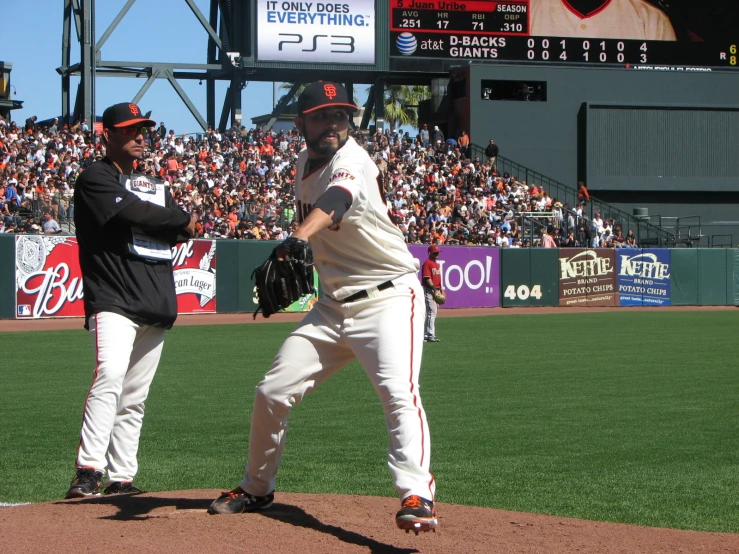 a man wearing a baseball uniform on top of a field