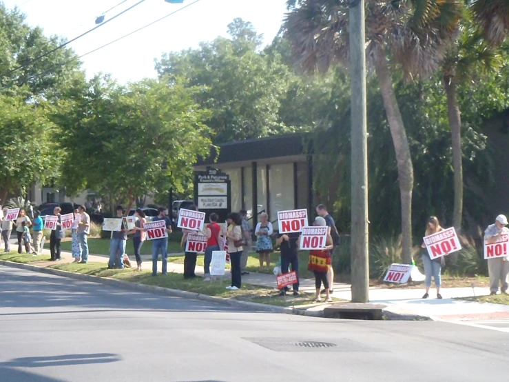 several people are protesting outside of a house