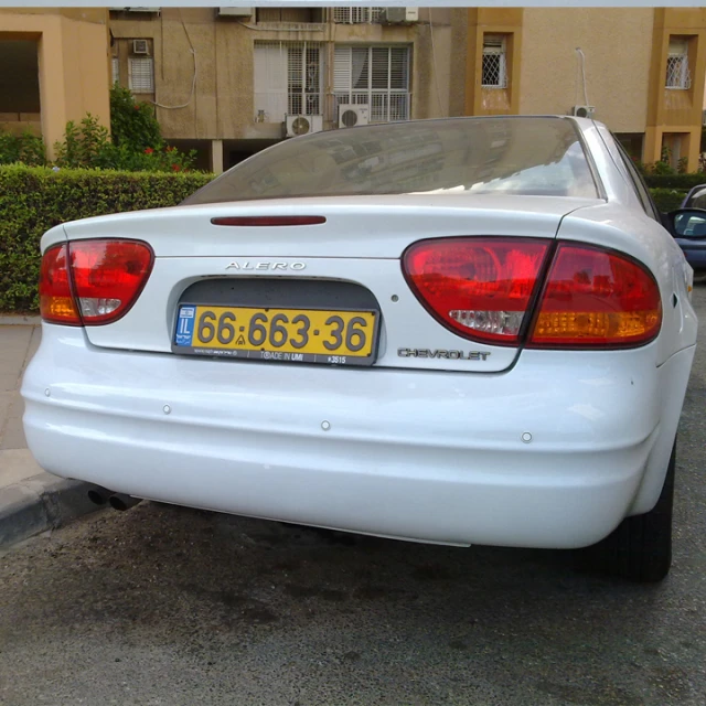 a white car that is sitting in the street