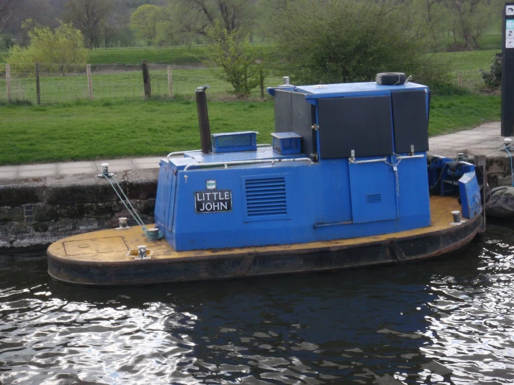 blue barge traveling through an open water channel