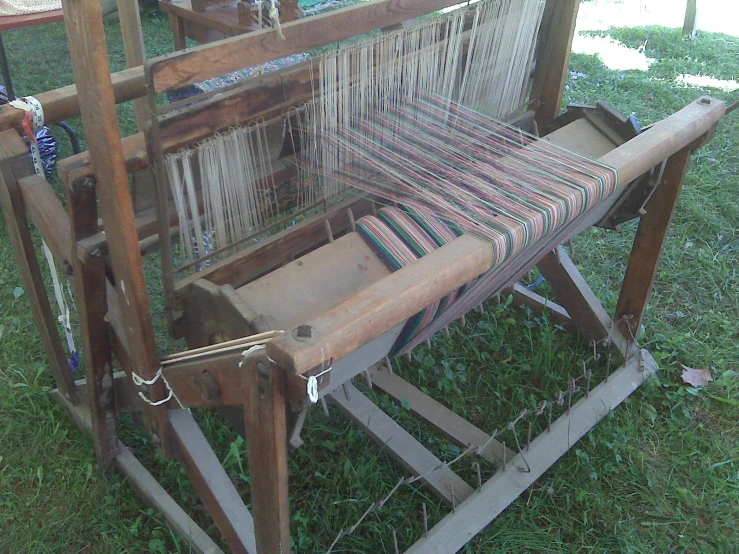 a long arm loom sits on the grass