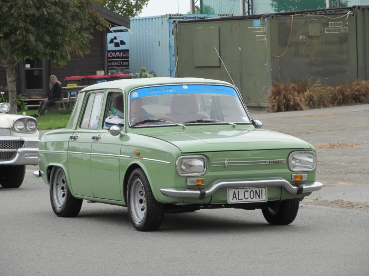 old green ford falcon on the road in europe