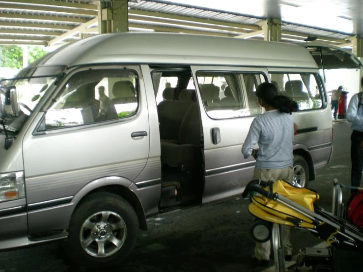 a woman is loading her car with luggage