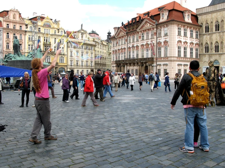 a large crowd of people in front of an old building