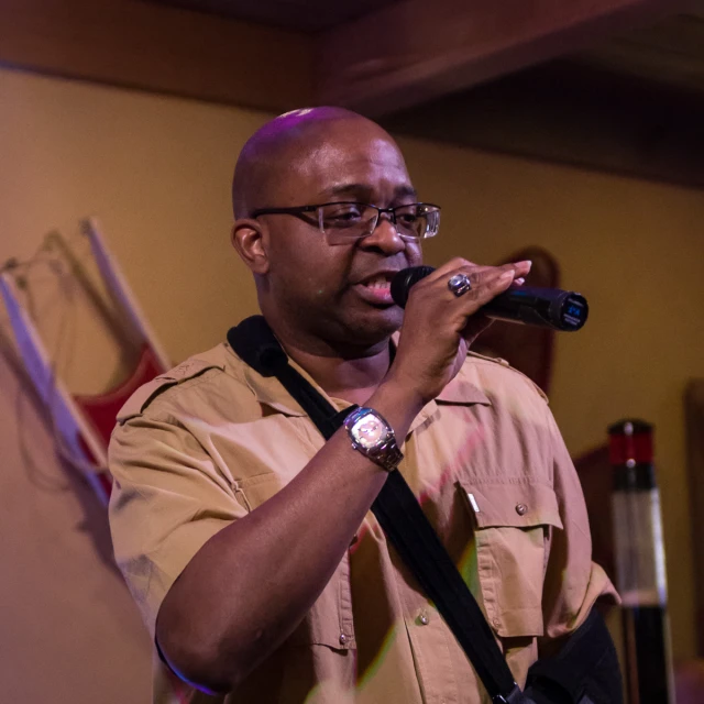 a man holds a microphone in his hands