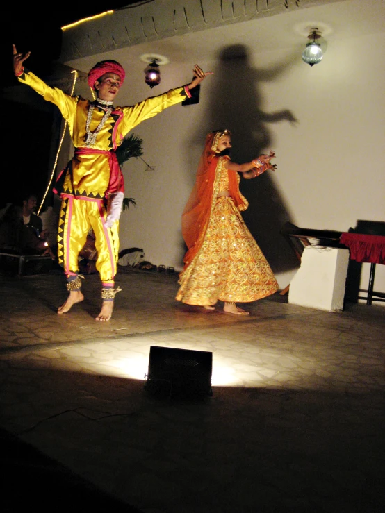 people performing traditional indian dance on a floor