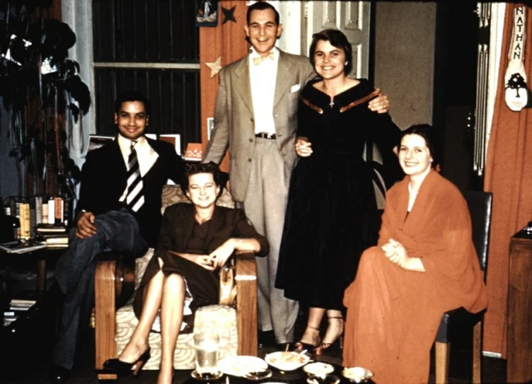 the family is posing for a portrait in the living room