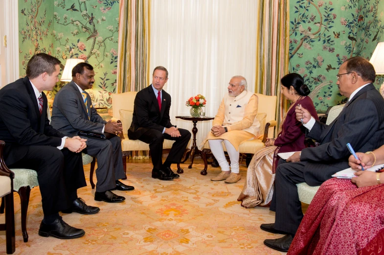 a group of men and women sitting around each other