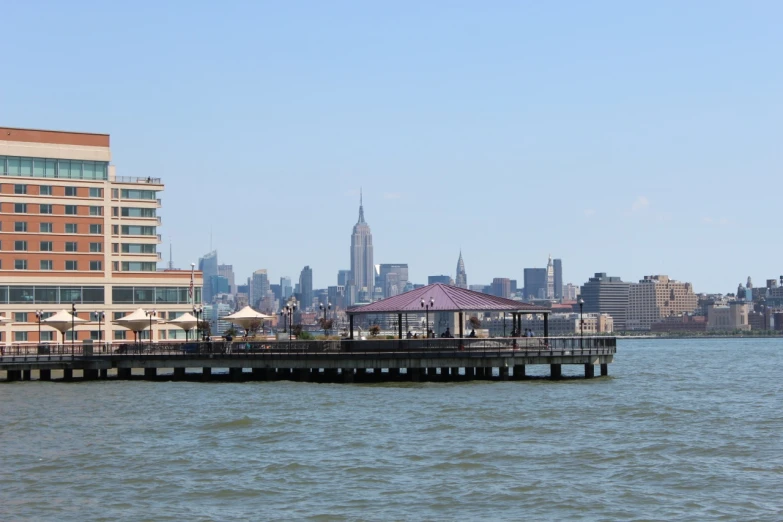 the view from the water of a cityscape and pier