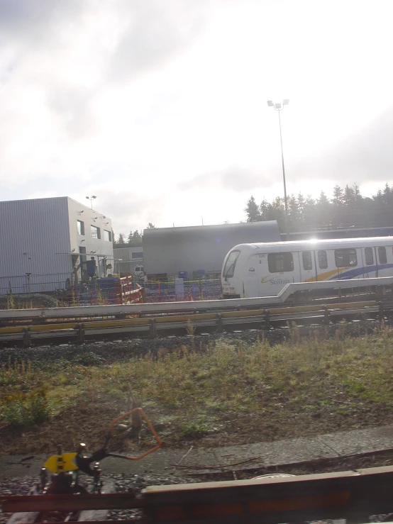 a train is parked beside a building near grass