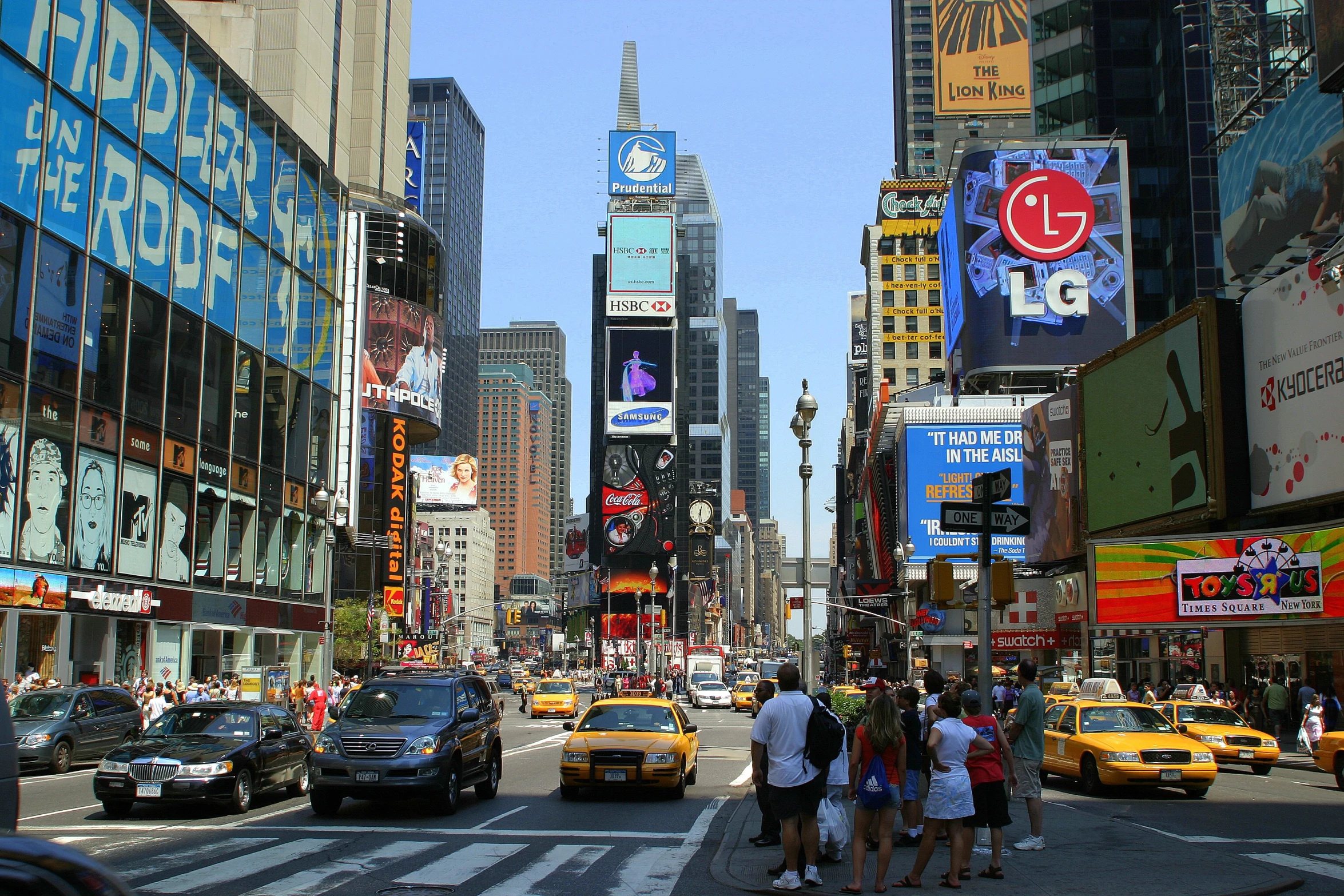 a busy intersection in new york with pedestrians crossing the street