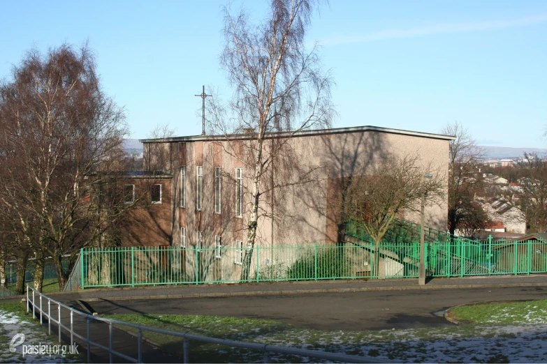 a very big building that is behind a fence