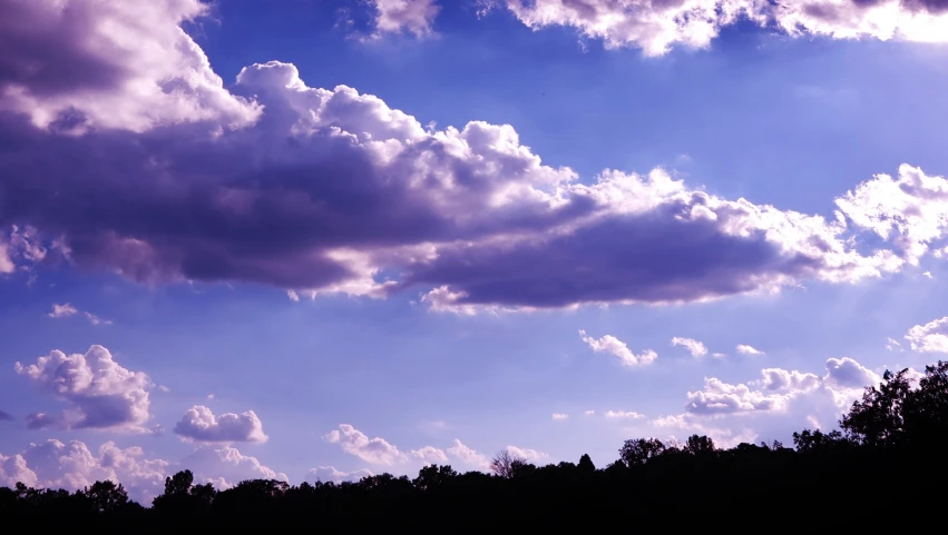 the sky is full of clouds as the sun sets