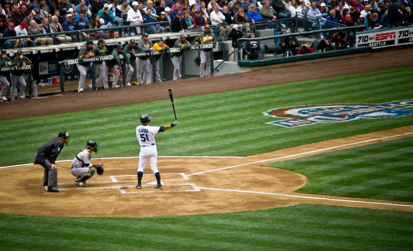 a baseball player holding a bat next to home plate
