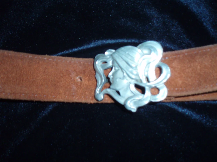 a belt that has a silver metal buckle on it