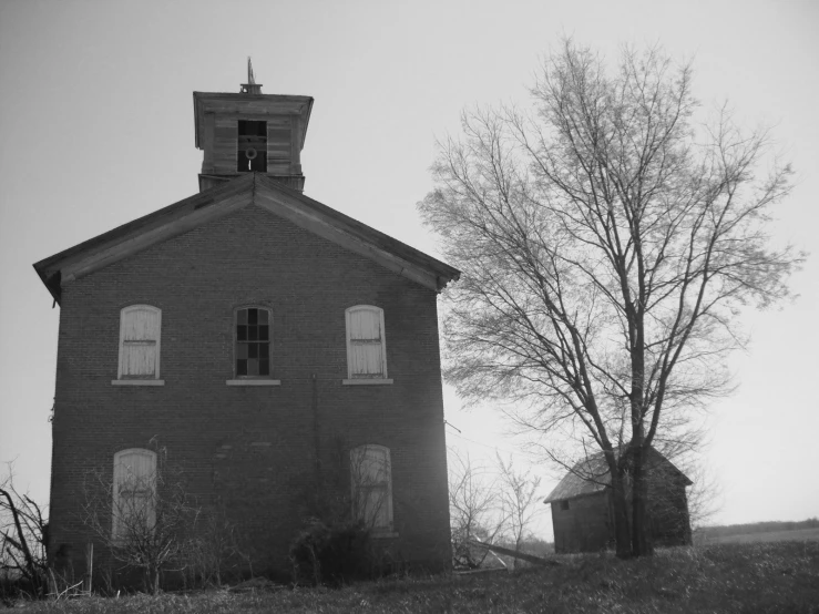 a lone tree sits next to a church